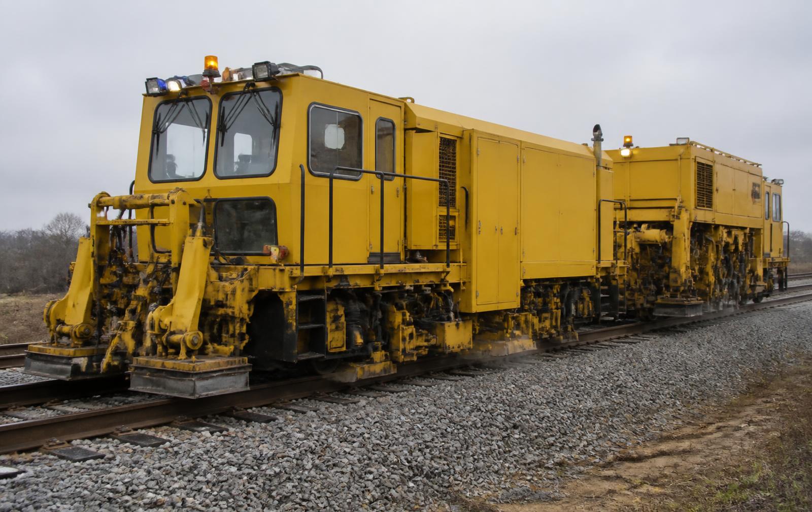 Unbranded ballast regulator and dynamic stabilizer working on ballasted track